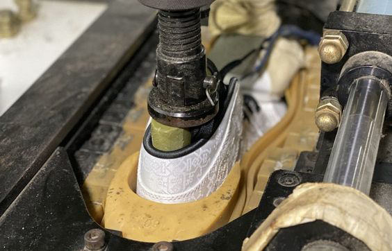 Factory production line preparing sneaker pairs